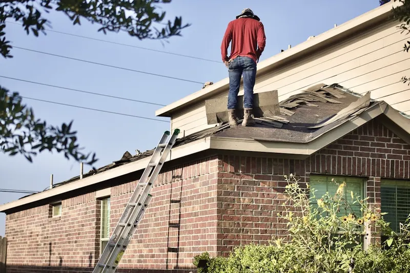 Professional roofer working on a residential roof in Crosspointe